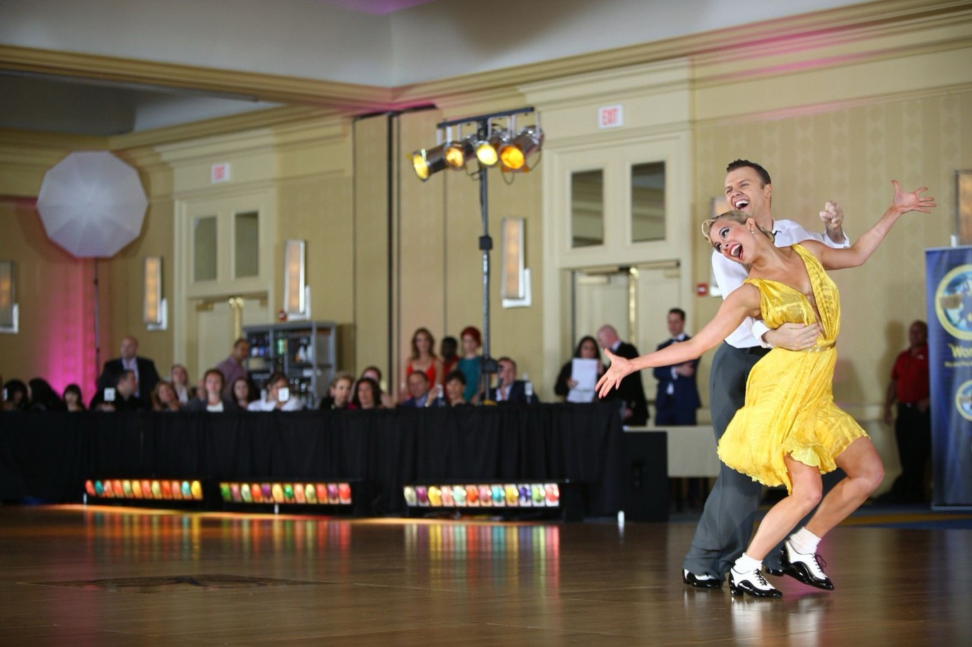 Slawek Roszak dancing American Smooth with a partner in yellow