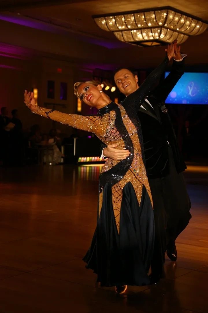 Slawek Roszak dancing Standard under a ballroom chandelier